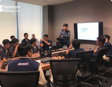 A group of professionals attends a training session on ERP software implementation in a conference room.